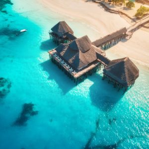 Aerial view of beautiful hotel on the water in ocean at sunset