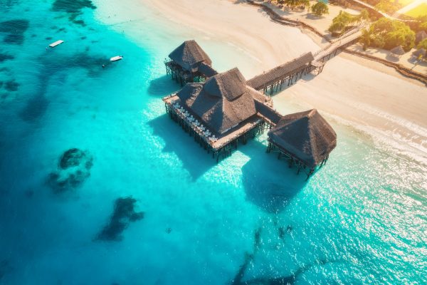 Aerial view of beautiful hotel on the water in ocean at sunset